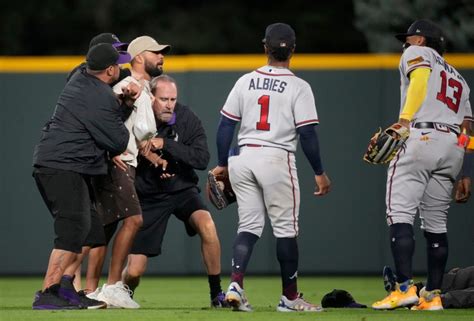 After fans rush Coors Field, safety concerns raised